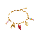 Gold bracelet with various charms including a fish, dolphin, lobster, and shell on a white background.