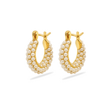Gold hoop earrings with pearl beads on a white background