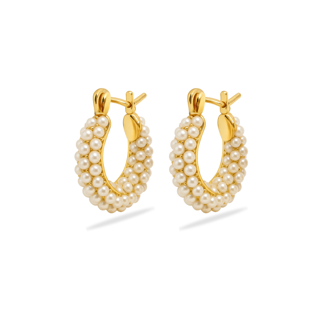 Gold hoop earrings with pearl beads on a white background