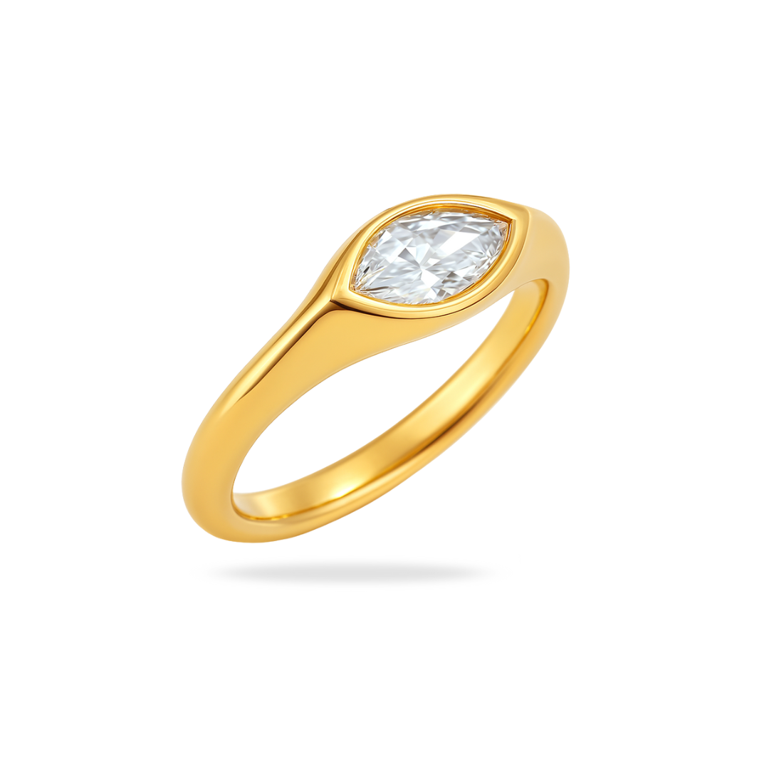 Gold ring with a clear gemstone on a white background